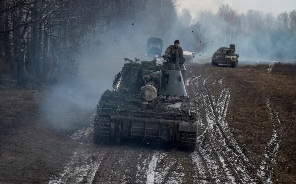 Ukrainian servicemen in armoured vehicles take part in a drill at the border with Belarus - Reuters