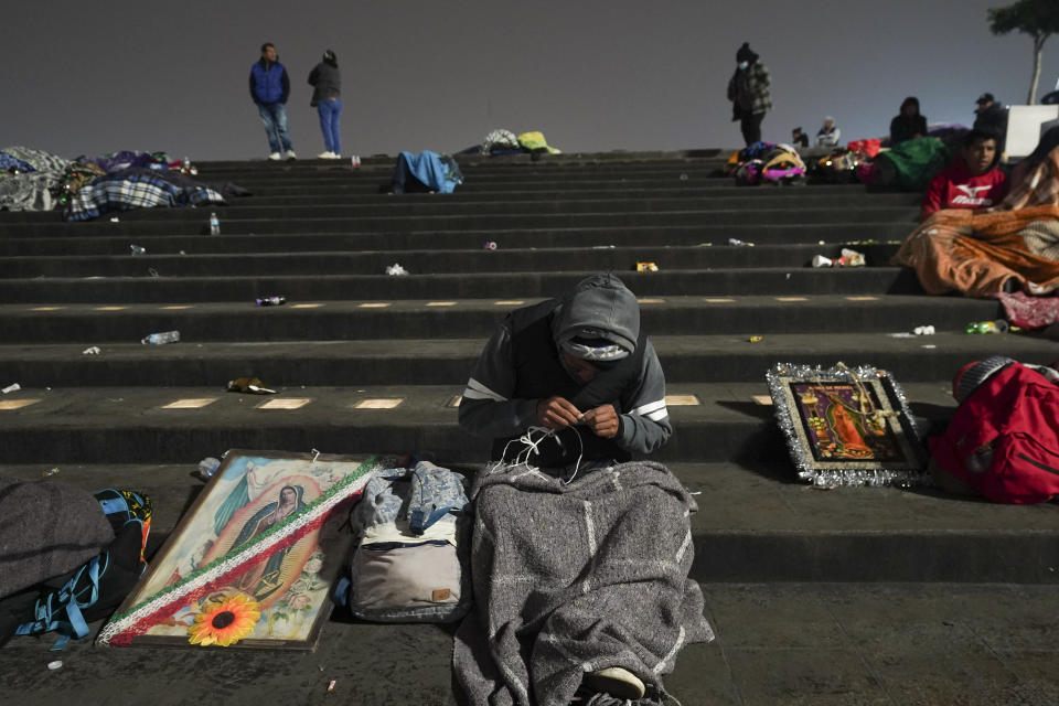 Pilgrims gather outside the Basilica of Guadalupe on her feast day in Mexico City, early Tuesday, Dec. 12, 2023. Devotees of Our Lady of Guadalupe gather for one of the world's largest religious pilgrimages on the anniversary of one of several apparitions of the Virgin Mary witnessed by an Indigenous Mexican man named Juan Diego in 1531. (AP Photo/Marco Ugarte)