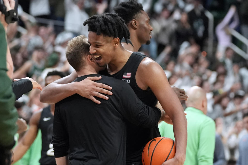 Michigan State guard A.J. Hoggard is hugged by a teammate after an NCAA college basketball game against Illinois, Saturday, Feb. 10, 2024, in East Lansing, Mich. (AP Photo/Carlos Osorio)