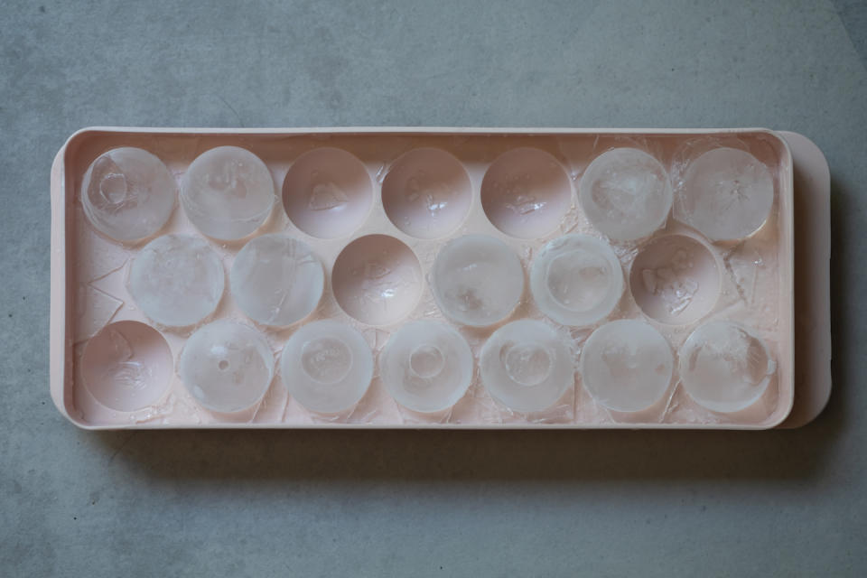 A frozen round ice in the plastic tray. for garbage diposal