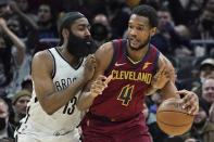 Cleveland Cavaliers' Evan Mobley (4) tries to get past Brooklyn Nets' James Harden (13) in the second half of an NBA basketball game, Monday, Jan. 17, 2022, in Cleveland. (AP Photo/Tony Dejak)