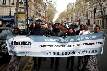 People take part in a silent walk to commemorate the 25th anniversary of the Rwandan genocide in Paris, France, April 7, 2019. REUTERS/Benoit Tessier