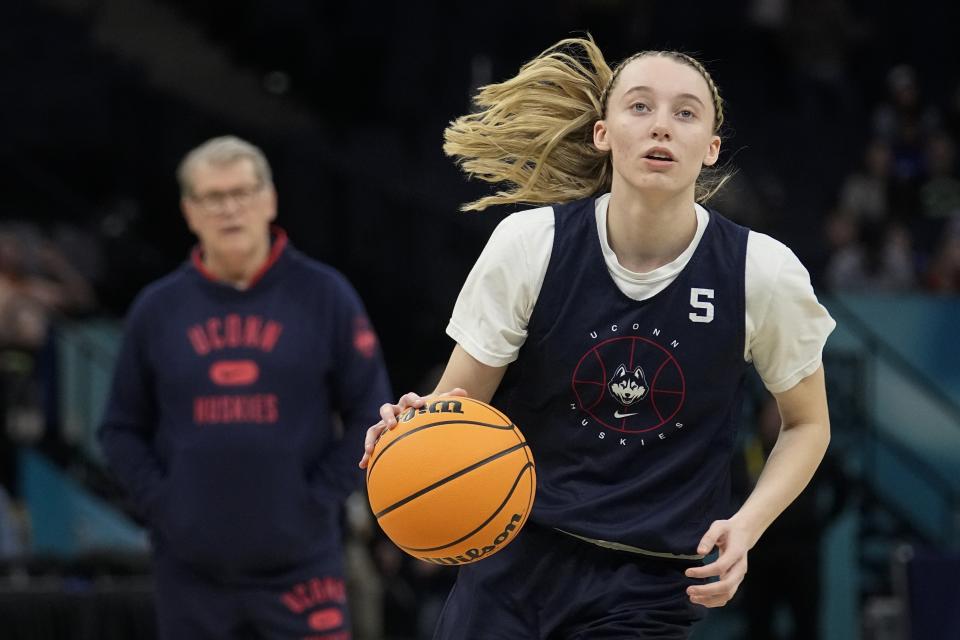 FILE - UConn's Paige Bueckers dribbles during a practice session for a college basketball game in the final round of the Women's Final Four NCAA tournament Saturday, April 2, 2022, in Minneapolis. Bueckers is participating in summer workouts as she prepares to return from knee issues that have kept her out for most of the past two seasons. (AP Photo/Eric Gay, File)