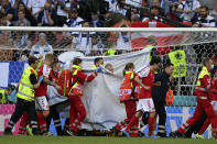 Denmark's Christian Eriksen is taken away on a stretcher after collapsing on the pitch during the Euro 2020 soccer championship group B match between Denmark and Finland at Parken Stadium in Copenhagen, Saturday, June 12, 2021. (Stuart Franklin/Pool via AP)