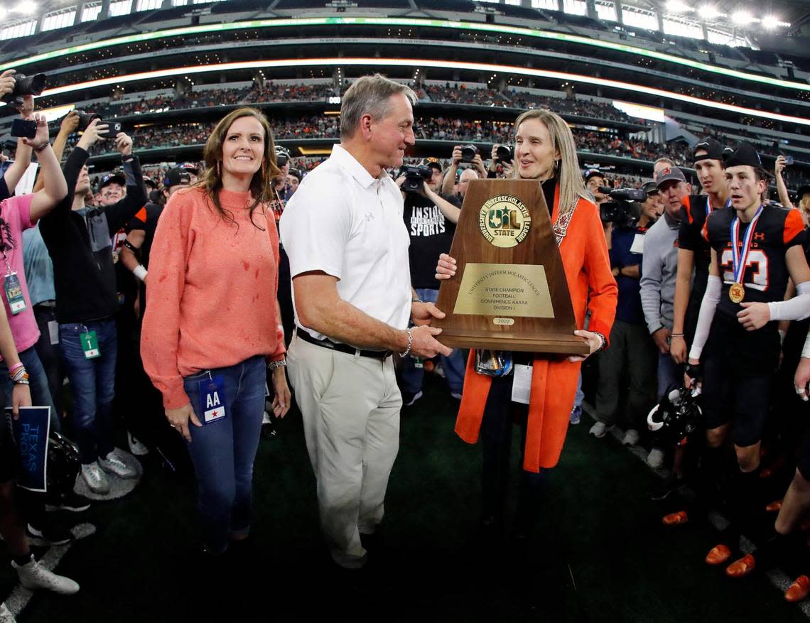 Aledo head coach Tim Buchanan receives the championship trophy after the UIL Class 5A D1 state championship football game at AT&T Stadium in Arlington, Texas, Saturday, Dec. 16, 2022. The Aledo Bearcats defeated The College Station Cougars 52-14. (Star-Telegram Bob Booth)