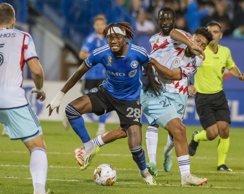 CF Montreal's Jules-Anthony Vilsaint fights his way through Chicago Fire players during the first half of an MLS soccer game in Montreal, Saturday, Sept. 16, 2023. (Peter McCabe/The Canadian Press via AP)