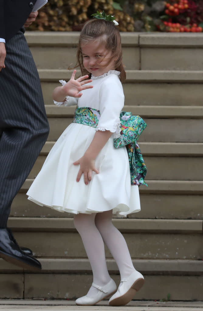 Princess Charlotte made sure she gave another quick regal wave to her fans from the St George’s Chapel steps before heading inside [Photo: Getty]