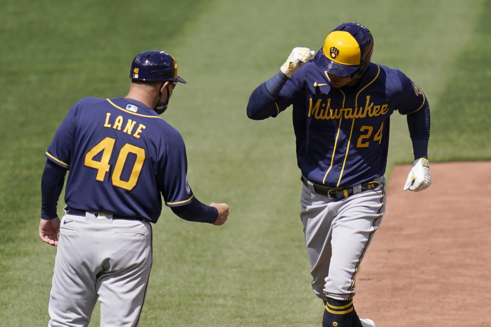 Milwaukee Brewers' Avisail Garcia (24) is congratulated by third base coach Jason Lane (40) after hitting a two-run home run during the fifth inning of a baseball game against the St. Louis Cardinals Saturday, April 10, 2021, in St. Louis. (AP Photo/Jeff Roberson)