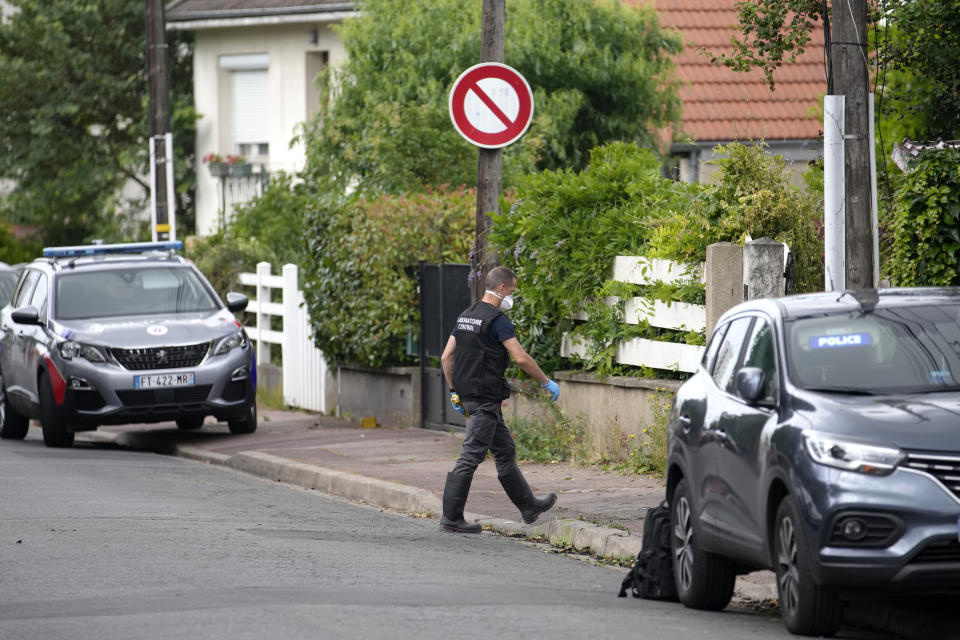 A police officer enters the house of L'Hay-les-Roses mayor, outside Paris, Sunday, July 2, 2023. Young rioters clashed with police and targeted the mayor's home with a burning car as France saw a fifth night of unrest sparked by the police killing of a teenager (AP Photo/Christophe Ena)