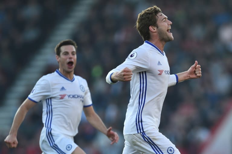 Chelsea's Marcos Alonso (R) celebrates scoring their third goal from a free kick during their match against Bournemouth at the Vitality Stadium in Bournemouth, southern England on April 8, 2017