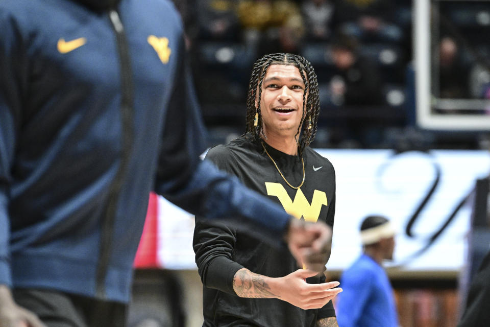 West Virginia Guard RaeQuan Battle looks on prior to the game against the Pittsburgh Panthers on Dec. 6, 2023, in Morgantown, WV. Battle, formerly of Montana State, has yet to play this season. College athletes like Battle who were denied the chance to play immediately after transferring a second time can return to competition, for now, after a federal judge issued a 14-day temporary restraining order Wednesday, Dec. 13, 2023, against the NCAA. (William Wotring/The Dominion-Post via AP)