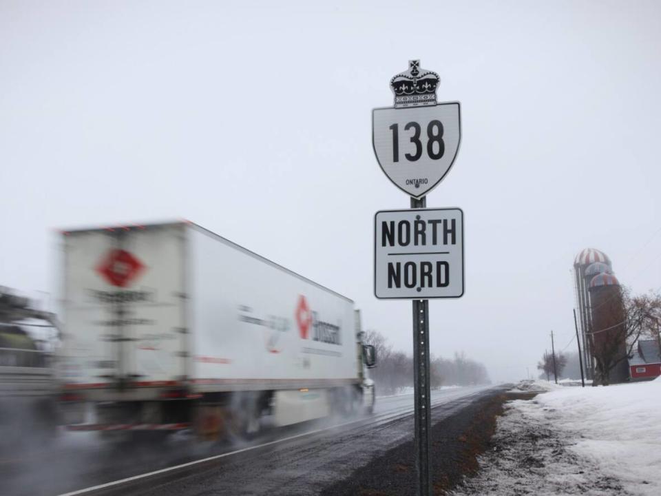 A pair of trucks make their way along Highway 138 near Monkland, Ont., earlier this month.  (Trevor Pritchard/CBC - image credit)