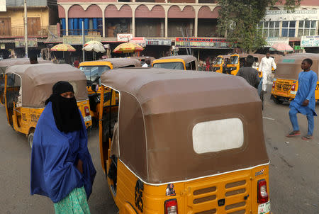 People move in a street after the postponement of the presidential election in Kano, Nigeria February 17, 2019. REUTERS/Luc Gnago