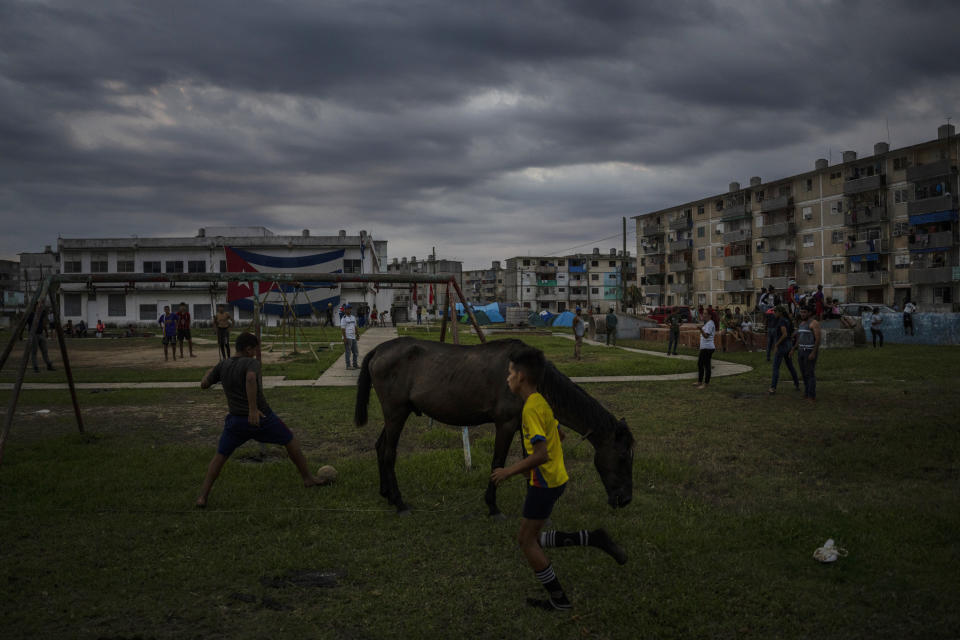 Children play ball in La Coloma, Pinar del Rio province, Cuba, Wednesday, Oct. 5, 2022, one week after Hurricane Ian. (AP Photo/Ramon Espinosa)