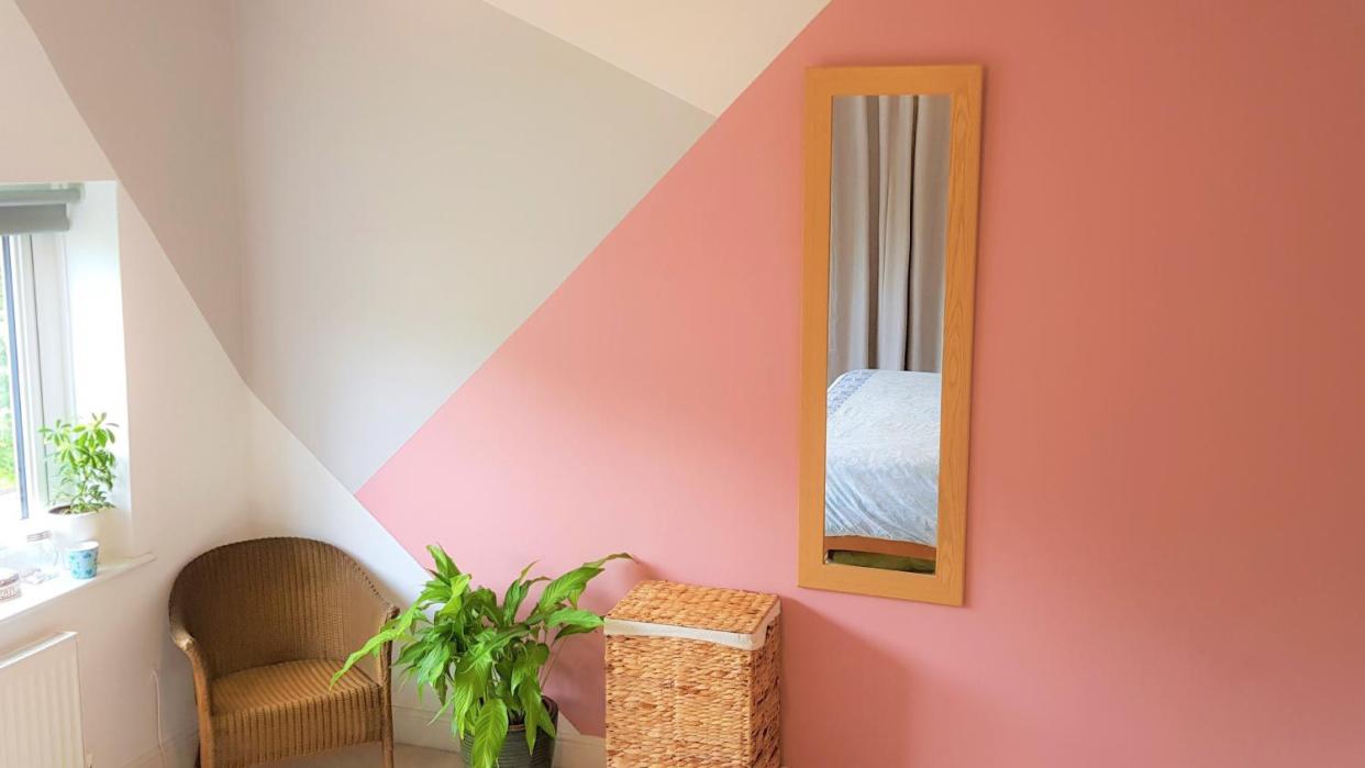 A bedroom with painted geometric pattern