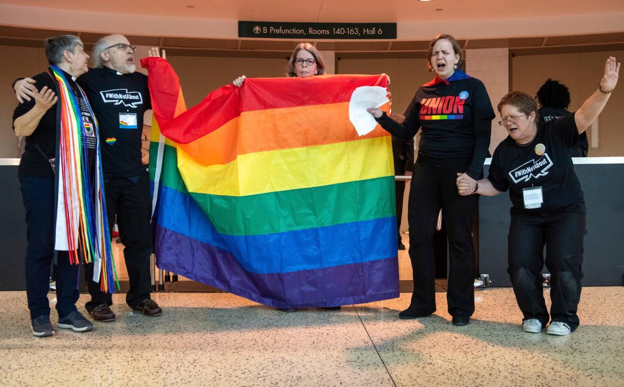 Protesters objecting to the adoption of a platform rejecting same-sex marriage and ordination of LGBT clergy gather outside the United Methodist Church's 2019 Special Session of the General Conference in St. Louis, Mo., Tuesday, Feb. 26, 2019. America's second-largest Protestant denomination faces a likely fracture as delegates at the crucial meeting move to strengthen bans on same-sex marriage and ordination of LGBT clergy. (AP Photo/Sid Hastings) ORG XMIT: MOSH113