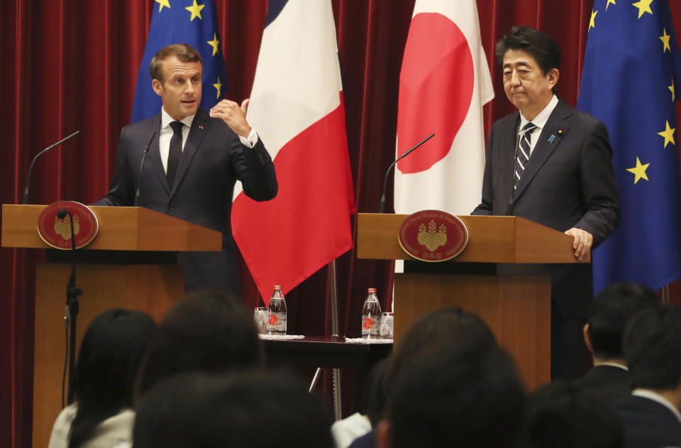 French President Emmanuel Macron, left, speaks as Japanese Prime Minister Shinzo Abe listens during their joint press conference at Abe's official residence in Tokyo, Wednesday, June 26, 2019. (AP Photo/Koji Sasahara,pool)