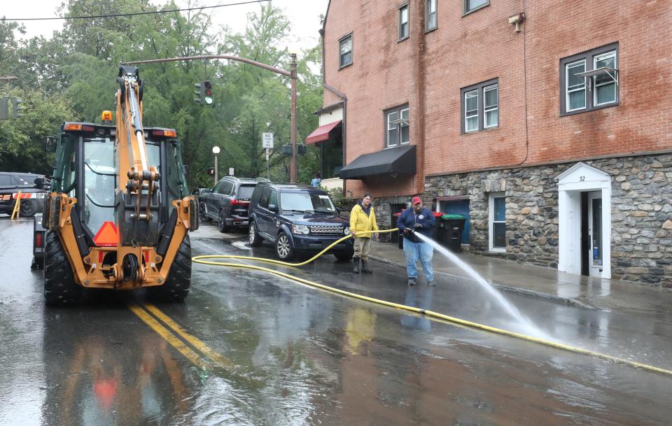 Village of Bronxville employees hose off mud on Paxton Avenue in Bronxville Sept. 30, 2023, after heavy rains the day before.