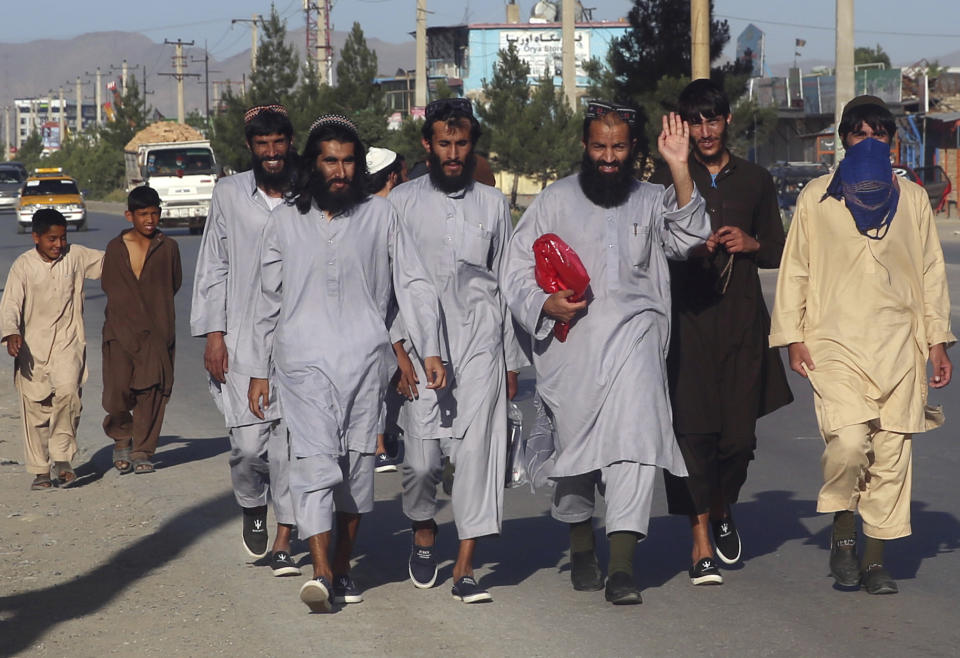 In this Tuesday, May 26, 2020 file photo, Afghan Taliban prisoners freed from Bagram prison walk in Kabul, Afghanistan. TAfghanistan has been at war for more than 40 years, first against the invading Soviet army that killed more than 1 million people, then feuding mujahedin groups in a bitter civil war followed by the repressive Taliban rule and finally the latest war that began after the 2001 U.S.-led coalition invasion that toppled the Taliban government. (AP Photo/ Rahmat Gul, File)