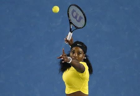 Serena Williams of the U.S. watches the ball as she hits a shot during her semi-final match against Poland's Agnieszka Radwanska at the Australian Open tennis tournament at Melbourne Park, Australia, January 28, 2016. REUTERS/Jason Reed