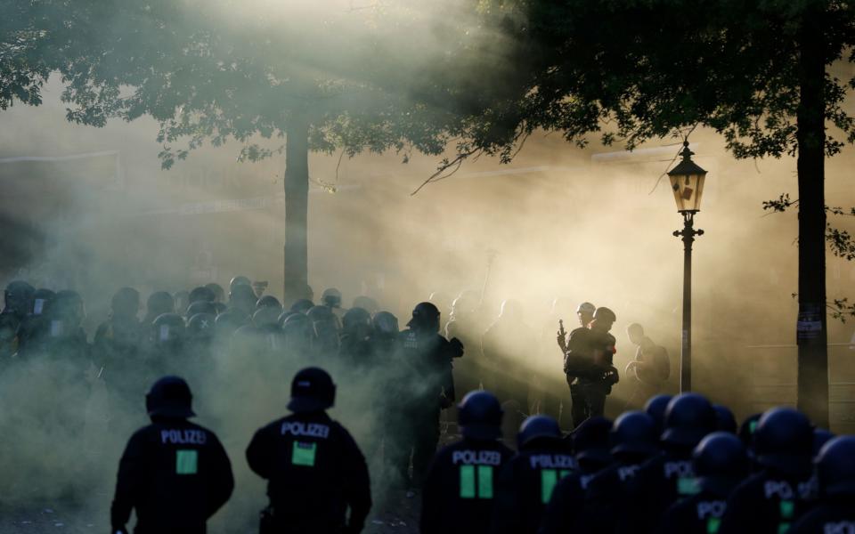 Riot police move in through the smoke during the "Welcome to Hell" rally against the G20 summit in Hamburg, - Credit: AFP