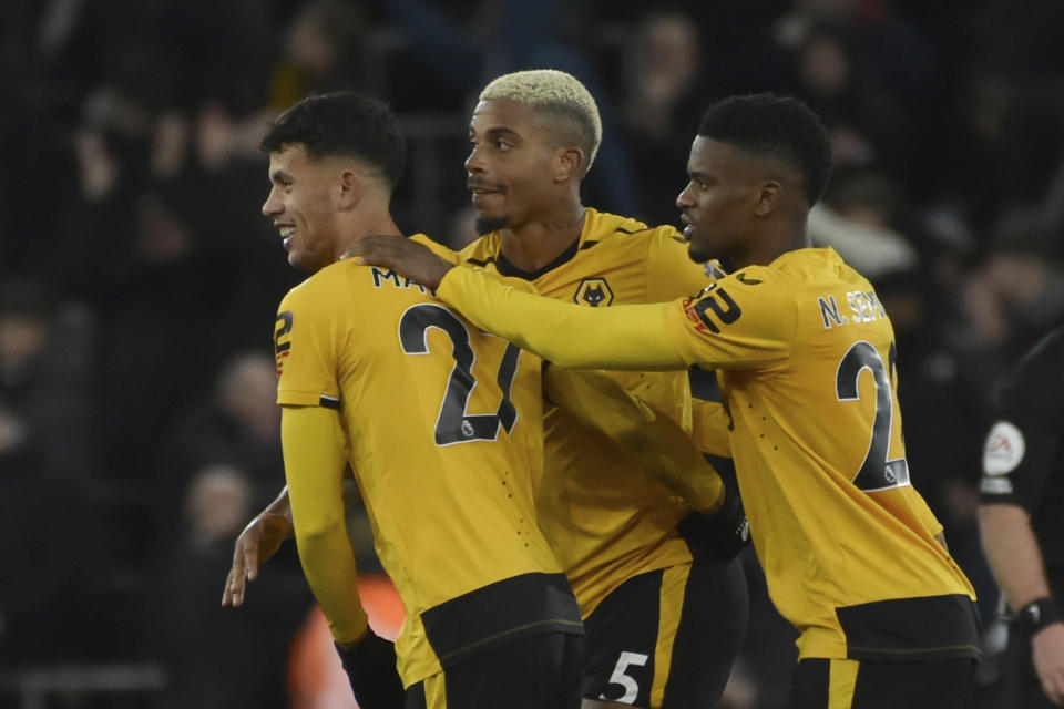 Wolverhampton Wanderers' Matheus Nunes, left Wolverhampton Wanderers' Mario Lemina, and Wolverhampton Wanderers' Nelson Semedo celebrate on the pitch after the end of the English Premier League soccer match between Wolverhampton Wanderers and West Ham United at Molineux Stadium in Wolverhampton, England, Saturday, Jan. 14, 2023. Wolves won the game 1-0. (AP Photo/Rui Vieira)