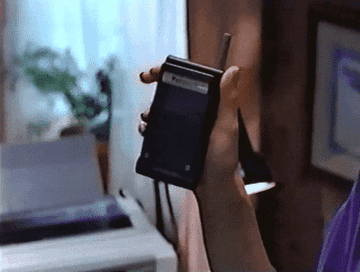 someone opening a very old flip phone