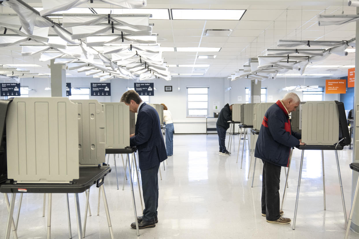 Ohio State Sen. Matt Dolan, left, a Republican candidate for U.S. Senate in Ohio, votes in the May 3 primary election in April in Cleveland.