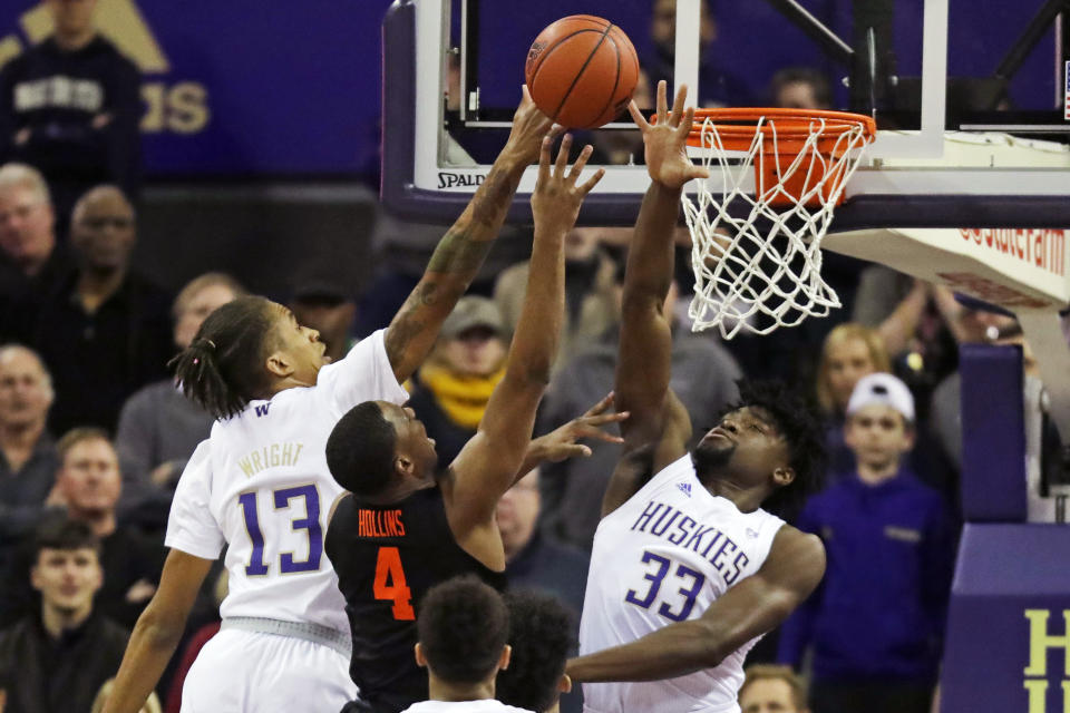 Oregon State forward Alfred Hollins (4) has a shot blocked by Washington forward Isaiah Stewart (33) and forward Hameir Wright (13) during the first half of an NCAA college basketball game Thursday, Jan. 16, 2020, in Seattle. (AP Photo/Ted S. Warren)