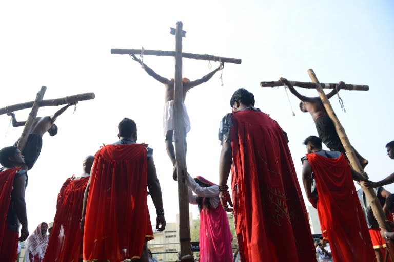 <p>Indian Catholic devotees re-enact the crucifixion of Jesus Christ during a ‘passion play’ tableau at Saint Joseph’s Cathedral in Hyderabad on March 25, 2016. Passion plays, a dramatic presentation depicting the suffering and death of Jesus Christ, are an integral part of Good Friday celebrations for Catholics. </p>