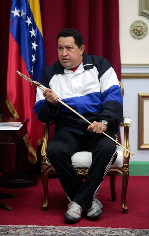 Venezuelan President Hugo Chavez holds a replica of Liberator Simon Bolivar's sword, on December 10, 2012 in Caracas. Chavez, who was re-elected president in October, has picked Nicolas Maduro to fill in should his cancer make it impossible for him to be sworn in for a new term on January 10