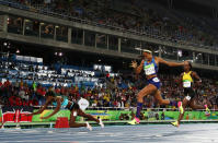 Shaunae Miller of the Bahamas dives to win gold over American Allyson Felix in the Women’s 400m.