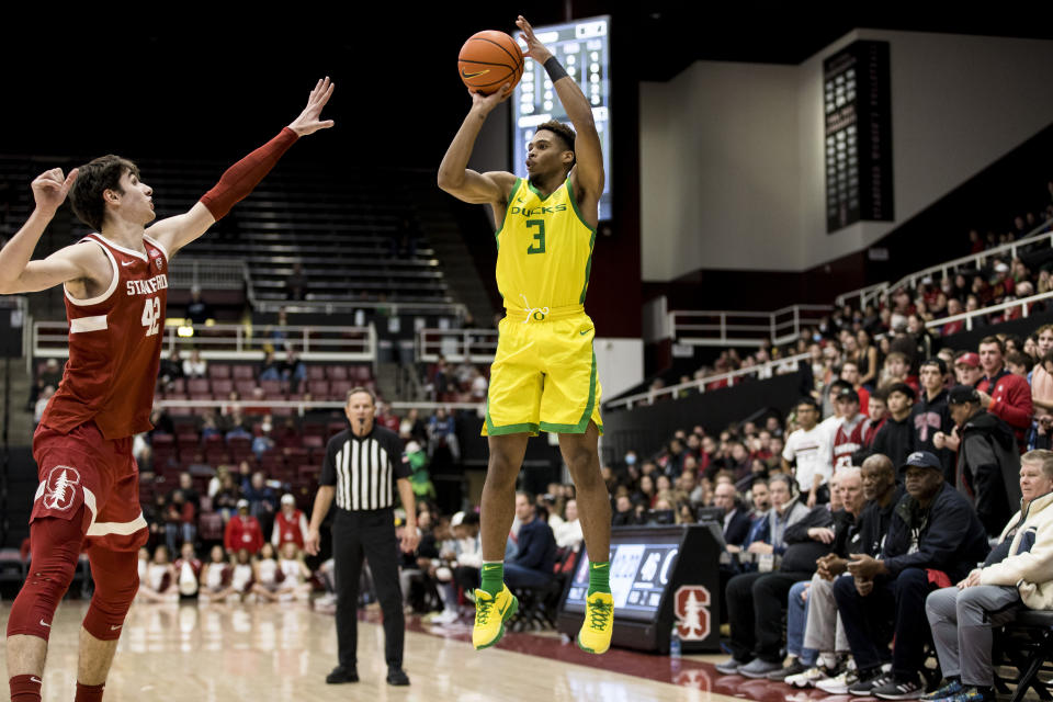 Oregon guard Keeshawn Barthelemy (3) takes a 3-point shot over Stanford forward Maxime Raynaud during the second half of an NCAA college basketball game in Stanford, Calif., Saturday, Jan. 21, 2023. Stanford won 71-64. (AP Photo/John Hefti)