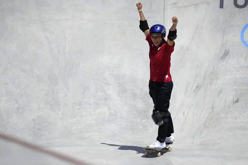 Sakura Yosozumi of Japan celebrates her run in the women's park skateboarding finals at the 2020 Summer Olympics, Wednesday, Aug. 4, 2021, in Tokyo, Japan. (AP Photo/Ben Curtis)