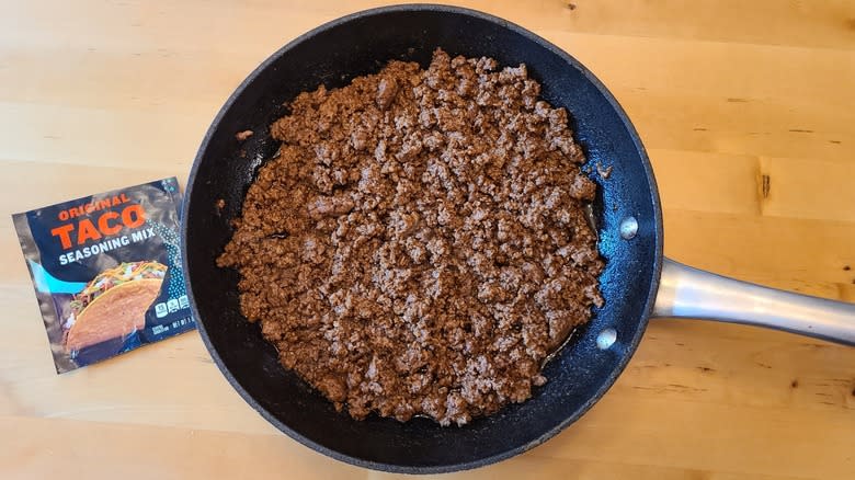 ground beef in pan with taco seasoning