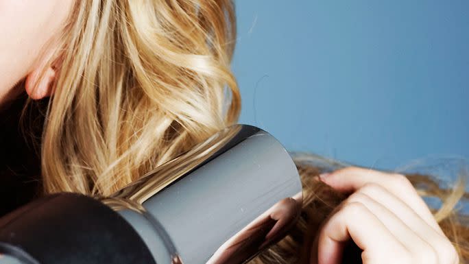 Close up image of blonde hair being blow-dried