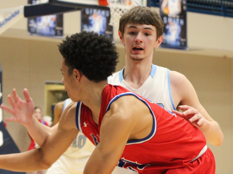 Bartlesville High School's Nick Smith guards an opposing player during basketball action this week.