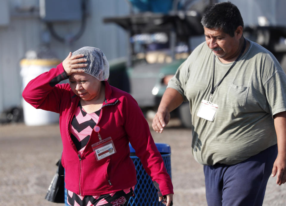 Koch Foods Inc., employees leave the Morton, Miss., plant following a raid by U.S. immigration officials in Morton, Miss., Wednesday, Aug. 7, 2019. U.S. immigration officials raided several Mississippi food processing plants on Wednesday and signaled that the early-morning strikes were part of a large-scale operation targeting owners as well as employees. (AP Photo/Rogelio V. Solis)