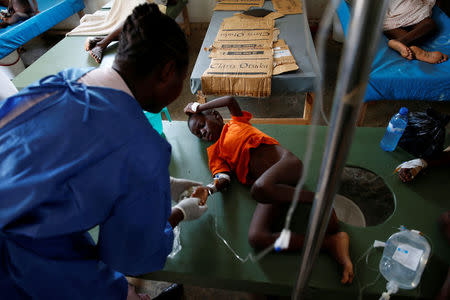 A child is being treated at the cholera treatment center at the hospital after Hurricane Matthew passes in Jeremie, Haiti, October 9, 2016. REUTERS/Carlos Garcia Rawlins