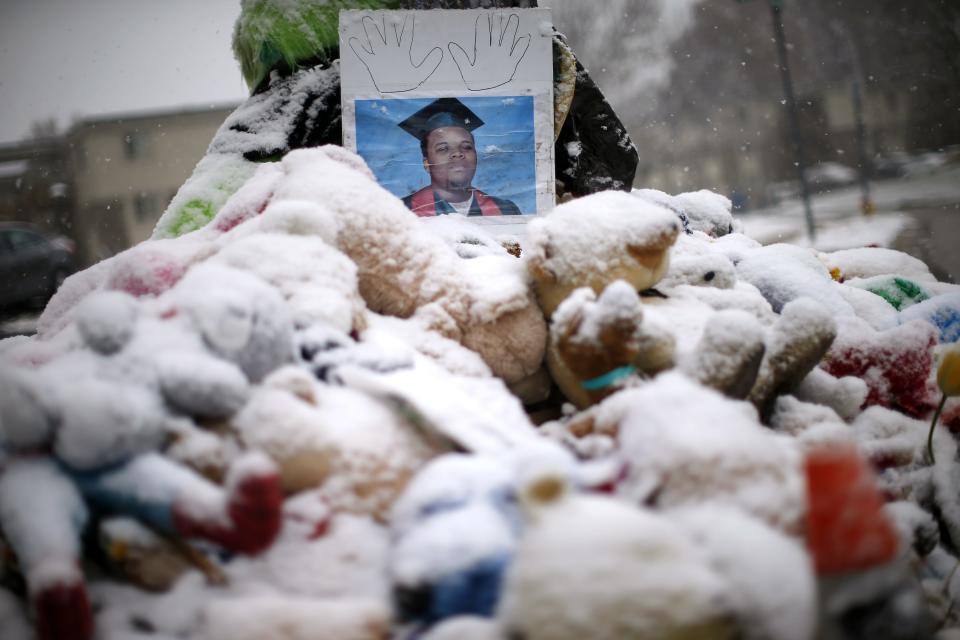 Snow falls on a memorial on the 100th day since the shooting death of Michael Brown in Ferguson