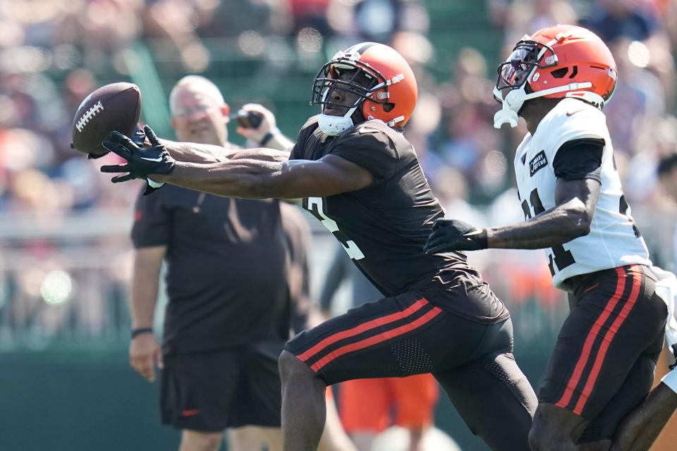 Cleveland Browns wide receiver Amari Cooper reaches for a pass in front of Cleveland Browns cornerback Denzel Ward (21) during training camp Aug. 20, 2023, in Berea.