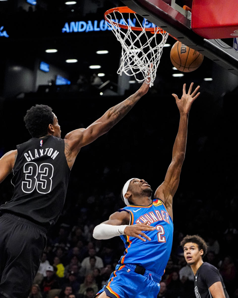 Oklahoma City Thunder guard Shai Gilgeous-Alexander (2) shoots while defended by Brooklyn Nets center Nic Claxton (33) during the first half of an NBA basketball game in New York, Friday, Jan. 5, 2024. (AP Photo/Peter K. Afriyie)