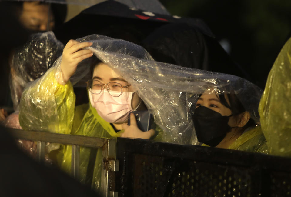 Fans wait outside of the red carpet at the 58th Golden Horse Awards in Taipei, Taiwan, Saturday, Nov. 27, 2021. (AP Photo/Chiang Ying-ying)