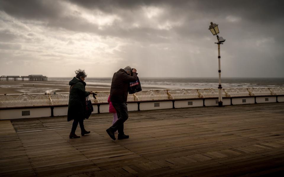 People brave the wind and rain on Blackpool's North Pier