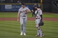 Detroit Tigers starting pitcher Spencer Turnbull, left walks with catcher Eric Haase at the end of the seventh inning of the team's baseball game against the Seattle Mariners, Tuesday, May 18, 2021, in Seattle. (AP Photo/Ted S. Warren)