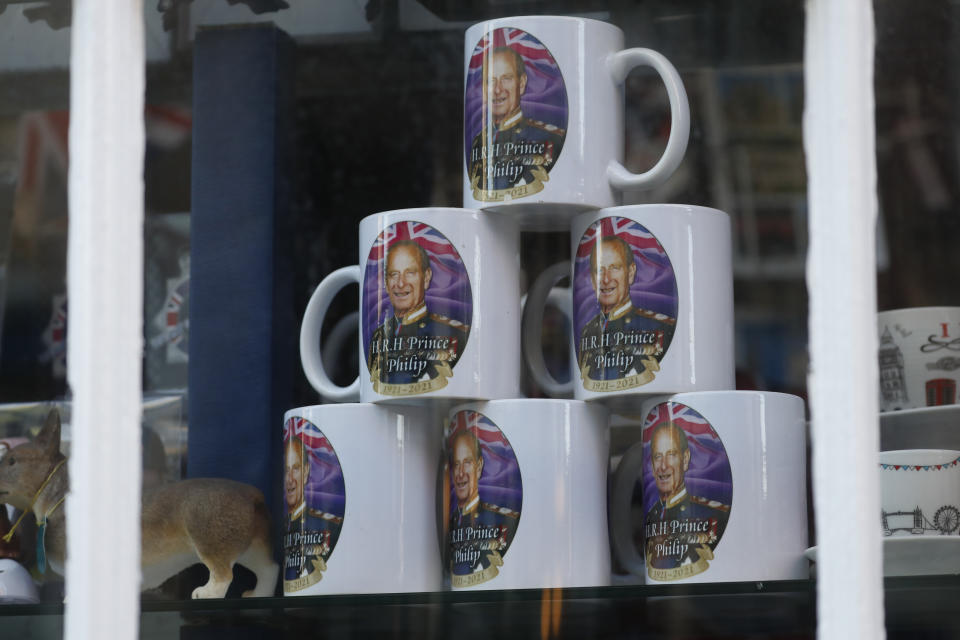 Memorabilia mugs showing a photograph of Britain's Prince Philip on sale at a shop in Windsor, England, Friday, April 16, 2021. Prince Philip husband of Britain's Queen Elizabeth II died April 9, aged 99, his funeral will take place Saturday at Windsor Castle in St George's Chapel. (AP Photo/Alastair Grant)