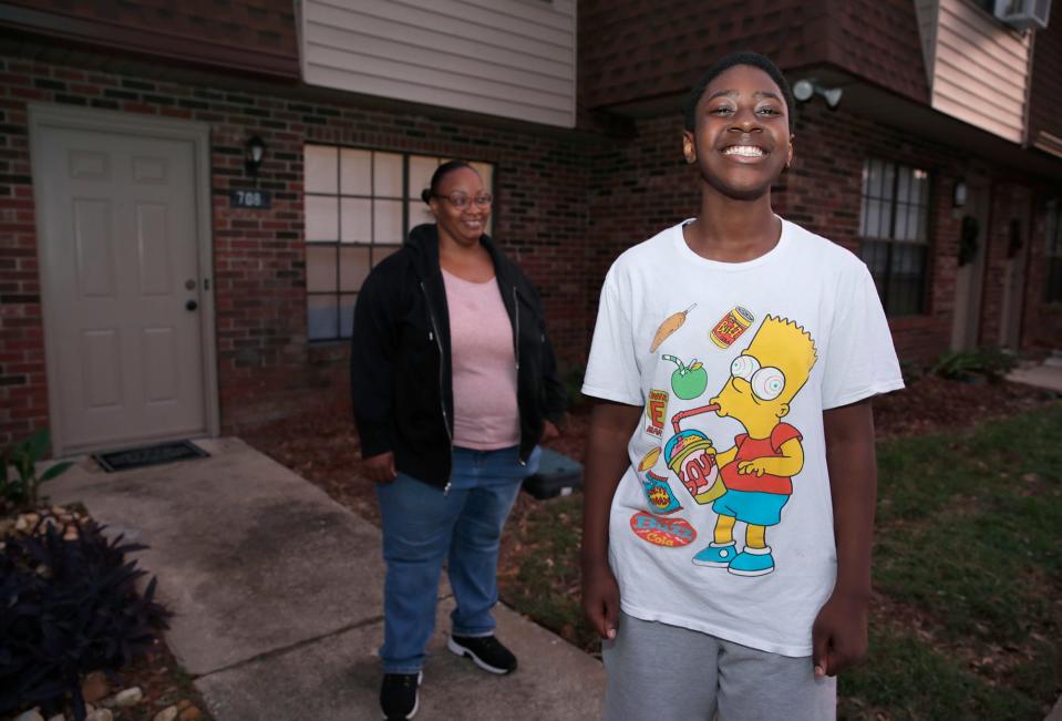 Christian Hooks, 12, along with his mom, Catrina McMillan, outside their Port Orange home Monday, Nov. 21. McMillan used resources from Food Brings Hope after her home and car flooded from Tropical Storm Ian. Christian, a seventh-grader at Campbell Middle School, also participates in the TeenZone program, which is sponsored by Food Brings Hope and provides before- and after-school tutoring, meals, activities and field trips.