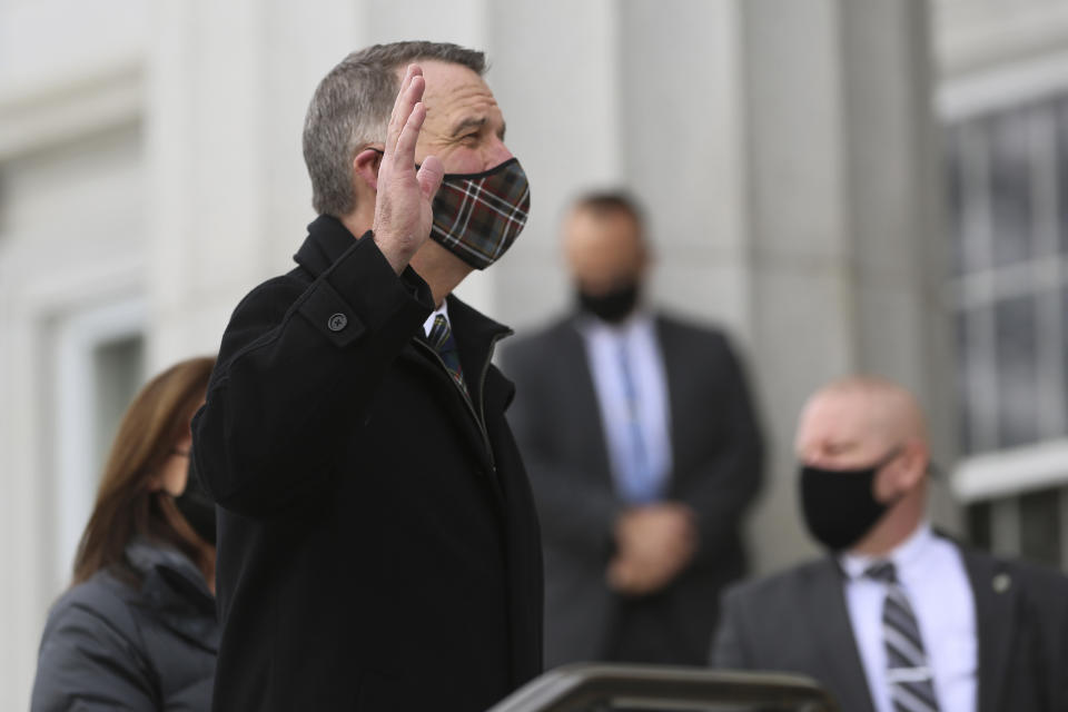 FILE - In this Thursday, Jan. 7, 2021 file photo, Republican Gov. Phil Scott wears a mask as he takes the Oath of Office on the steps of the Vermont Statehouse in Montpelier, Vt., beginning his third two-year term. With the pandemic relief law signed by President Joe Biden in 2021, Scott says, “I think we’re in a pivotal time. ... A billion dollars has just fallen from the sky, in some respects. It’s here, right in front of us. We have to invest it wisely.” (AP Photo/Wilson Ring)