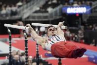 Sam Mikulak of the United States performs on the parallel bars during the American Cup gymnastics competition Saturday, March 7, 2020, in Milwaukee. (AP Photo/Morry Gash)