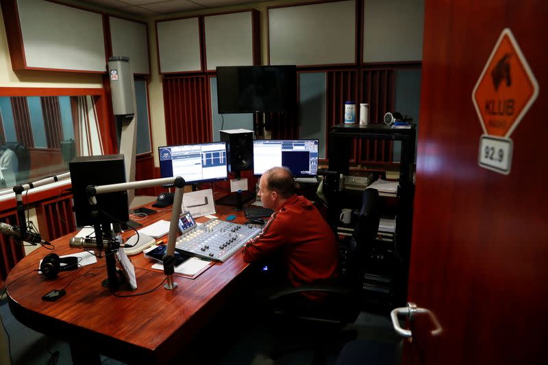 FILE PHOTO: An employee of the opposition radio-station Klubradio works at its headquarters in Budapest